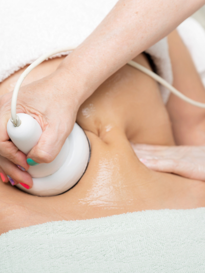 Professional slimming massage with cavitation treatment on abdominal area.