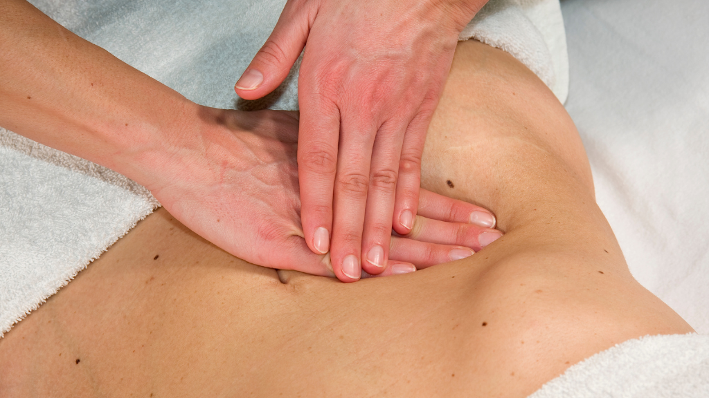 Professional lymphatic drainage massage technique on abdomen for post-surgery recovery at home in South Florida